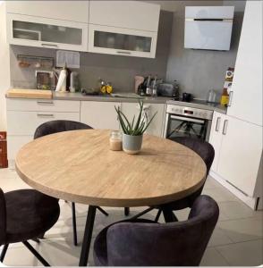 a kitchen with a wooden table and chairs at studio siesta in Pétange
