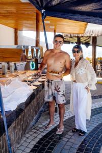 a man and a woman standing next to a table at El Aram Beach Cabo - All Inclusive in Cabo de Santo Agostinho +20 photos