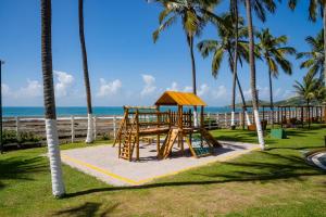 a playground at the beach with palm trees at El Aram Beach Cabo - All Inclusive in Cabo de Santo Agostinho