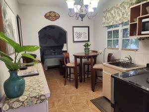 a kitchen with a table and a dining room at Wilche Cottage in Road Town