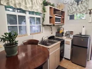 a kitchen with a table and a stove top oven at Wilche Cottage in Road Town