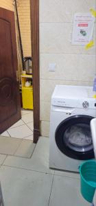 a washing machine sitting on the floor in a room at Shinam hostel 777 in Chilanzar