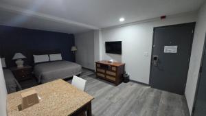 a hotel room with a bed and a desk and a room at Roosevelt Inn at Roosevelt Blvd, Philadelphia, PA in Philadelphia