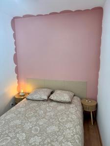 a bedroom with a large bed with two pillows at Le clos Ghisline in Madré