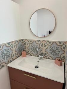 a bathroom with a sink and a mirror at Le clos Ghisline in Madré +16 photos