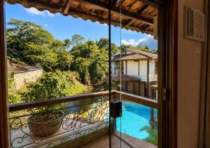 a room with a view of a pool from a balcony at Hotel Casa Encantada in Penedo