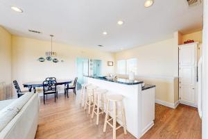 a kitchen and dining room with a table and chairs at Charming ocean-view gem with a pool deck washer dryer & central AC in St. George Island