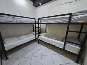 a room with three bunk beds in a room at Shinam hostel 777 in Chilanzar