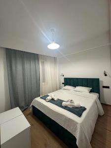 a bedroom with a large bed with towels on it at Aelio apartment in Ermoupoli