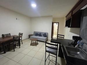 a living room with a couch and a table at Departamento Rousse in Tequila