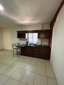 a kitchen with a table and chairs in a room at Departamento Rousse in Tequila