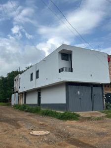 a large white building with aventh floor at Departamento Rousse in Tequila