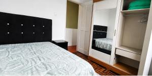 a bedroom with a large bed and a closet at Sobrado de esquina in Pelotas