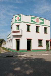 a large white building with red and green trim at Sobrado de esquina in Pelotas