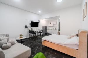 a bedroom with a bed and a living room at חופשה בממלכה in Ashkelon