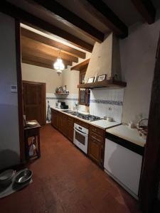 a kitchen with a sink and a stove top oven at Maison solognotte in Sainte-Montaine +3 photos