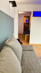 a living room with a couch and a bedroom at Ferienwohnung Hortwald am Schaumberg in Tholey