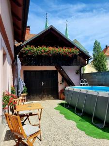 a patio with a table and a swimming pool at Pajtl indoor glamping in Črna na Koroškem