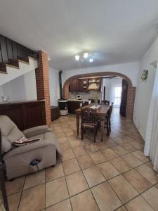 a living room with a table and a dining room at La casina dei nonni in Sinalunga