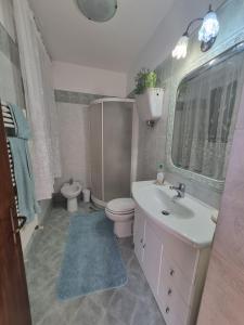 a bathroom with a white sink and a toilet at La casina dei nonni in Sinalunga +13 photos