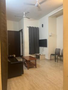 a living room with a couch and a table at Maxi villa maamalla in Mahabalipuram