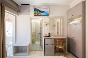 a small bathroom with a desk and a shower at Bikakis Family Apartments in Kissamos
