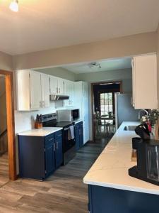 a kitchen with blue cabinets and a counter top at The Welcome Home in Topeka