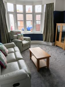 a living room with a couch and a coffee table at Flown The Nest in Bridlington