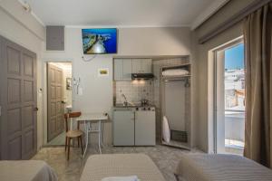 a small kitchen with a sink and a table at Bikakis Family Apartments in Kissamos +77 photos