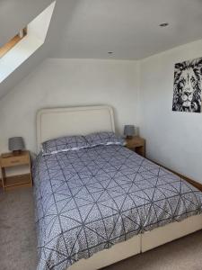 a bedroom with a bed and a picture on the wall at Flown The Nest in Bridlington