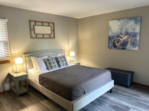 a bedroom with a large bed and two lamps at The Welcome Home in Topeka