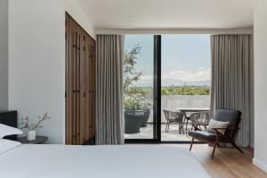 a bedroom with a bed and a view of a patio at Kimpton El Castelar Polanco by IHG in Mexico City +59 photos