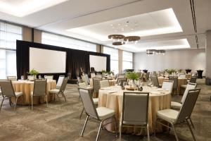 a conference room with tables and chairs and a screen at Archer Hotel Seattle/Redmond in Redmond +58 photos