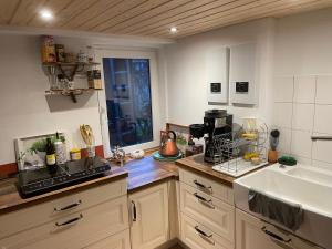 a kitchen with a sink and a counter top at Zimmer Mühlenbach, ein Zimmer in FeWo mit 2 Zi in Schieder-Schwalenberg