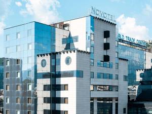 a building with a sign on the side of it at Novotel Grenoble Centre in Grenoble