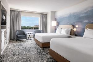a hotel room with two beds and a window at Harrah's Metropolis Hotel & Casino - A Caesars Rewards Destination in Metropolis +23 photos