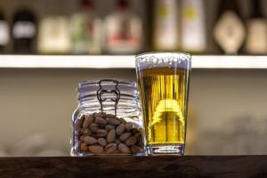 a glass jar of coffee beans and a cup of tea at Camp & Hostel Maltakva in Poti +2 photos