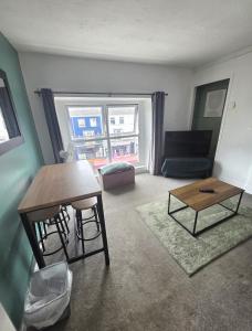 a living room with a table and a couch at Horizon Hideaway in Swansea