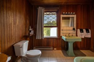 a bathroom with a toilet and a sink and a window at Auberge Les Sources in La Malbaie +175 photos