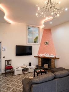 a living room with a fireplace and a tv at Il Borgo in Agerola