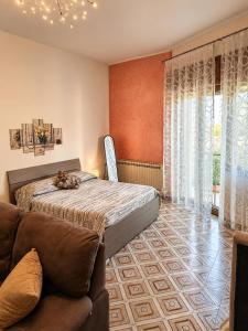 a bedroom with a bed and a couch at Il Borgo in Agerola