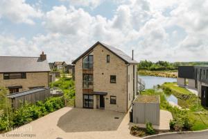 an aerial view of a house with a river at Knighton in Warmwell