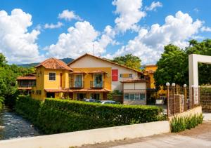 a yellow house with a fence at Hotel Casa Encantada in Penedo +72 photos