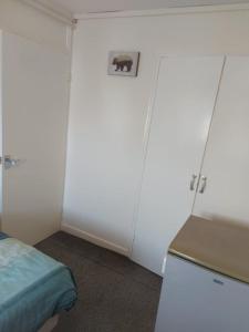 a room with two white doors and a bed at Private Room wigan in Atherton