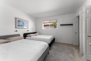 two beds in a room with white walls and a window at Baskets, Brews & Views: Epic Wenatchee Escape! in Wenatchee +29 photos