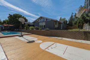 a basketball court in front of a house with a basketball hoop at Baskets, Brews & Views: Epic Wenatchee Escape! in Wenatchee