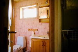 a bathroom with a sink and a toilet and a window at Sabines Sjöstuga in Bjärtrå +42 photos