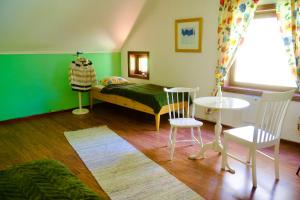 a bedroom with a bed and a table and chairs at Sabines Sjöstuga in Bjärtrå