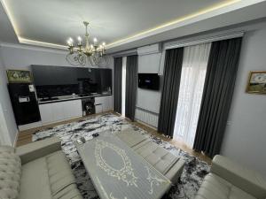 a living room with a couch and a chandelier at Madigul in Andijan