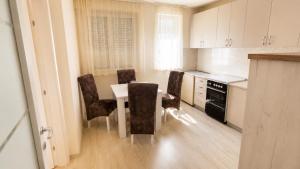 a kitchen with a table and chairs in a room at Harmony Relax in Paraćin